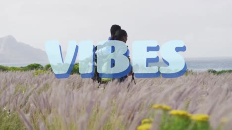Animation-of-the-word-vibes-written-in-blue-over-couple-hiking-in-countryside