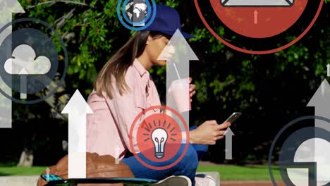 Digital-icons-and-arrows-moving-upwards-against-woman-using-smartphone-at-park