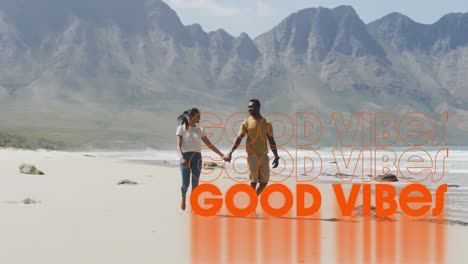 Animation-Der-Worte-„Good-Vibes“-In-Orange-über-Einem-Händchen-Haltenden-Paar,-Das-Am-Strand-Spaziert
