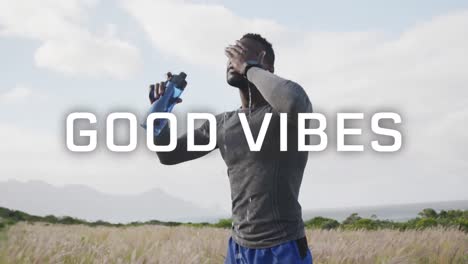 Animation-of-the-words-good-vibes-written-in-white-over-man-exercising-outdoors-cooling-off