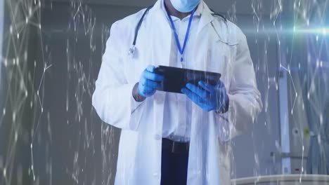 Animation-of-network-of-digital-icons-over-male-doctor-using-tablet