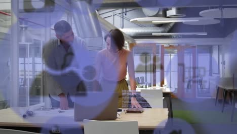 Animation-of-clock-moving-fast-over-business-colleagues-using-laptop