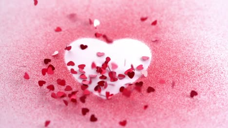 Animation-of-red-hearts-falling-over-pink-powder-forming-white-heart