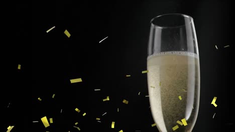Animation-of-glass-of-champagne,-with-gold-confetti-falling-on-black-background