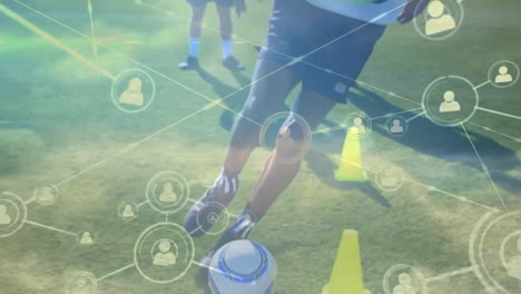 Animation-of-network-of-connections-with-people-icons-over-football-players-practicing