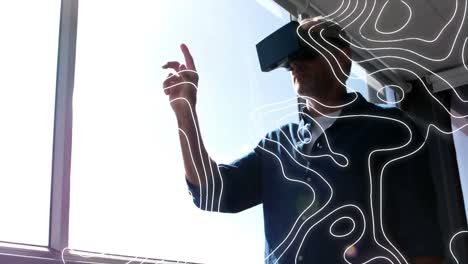 Animation-of-moving-topographic-chart,-over-man-in-vr-headset-gesturing-on-virtual-interface