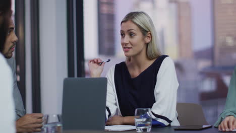 Video-of-caucasian-businesswoman-talking-to-colleagues-at-office-meeting