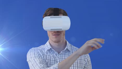 Animation-of-glowing-light-over-businessman-in-vr-headset-touching-screen
