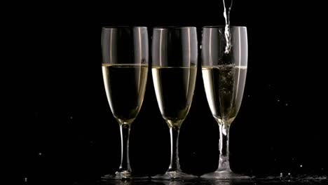 Animation-of-three-champagne-glasses-on-black-background