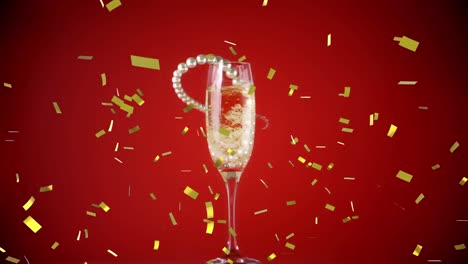 Animation-Von-Goldenem-Konfetti-Und-Perlenkette,-Die-In-Ein-Glas-Champagner-Auf-Rotem-Hintergrund-Fällt