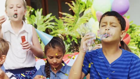 Animation-of-confetti-falling-over-children-blowing-bubbles-and-having-fun-at-party