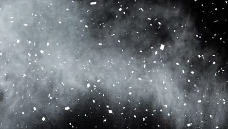 Animation-of-white-confetti-and-white-powder,-floating-on-black