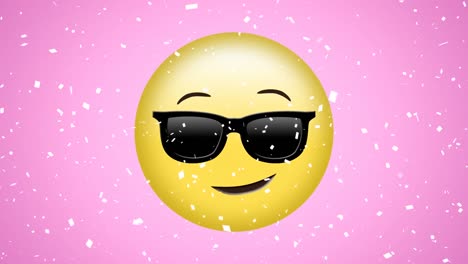 Animation-of-white-confetti-falling-over-happy,-cool-emoji-in-sunglasses,-on-pink-background
