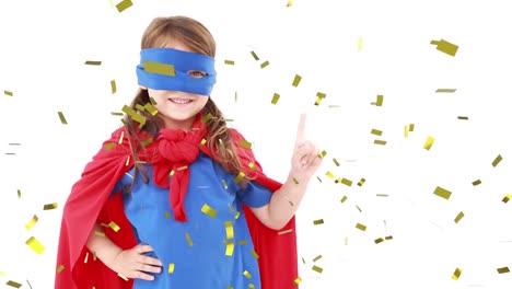 Animation-of-gold-confetti-falling-over-happy-girl-in-superhero-party-costume-waving