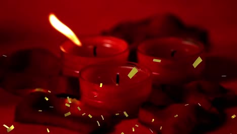 Animation-of-golden-confetti-over-red-candles