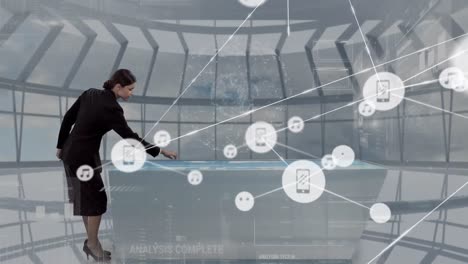 Animation-of-network-of-connections-with-icons-over-businesswoman-using-interactive-screen
