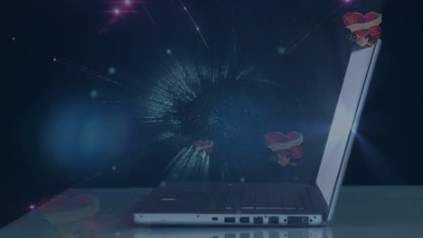Animation-of-globe-with-hearts-and-fireworks-over-laptop