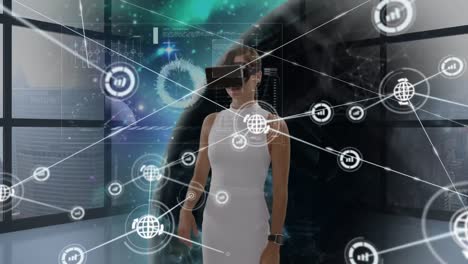 Animation-of-network-of-connections-with-icons-over-businesswoman-wearing-vr-headset