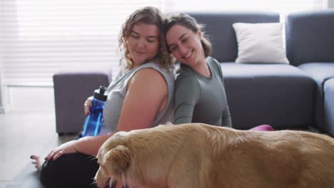 Caucasian-lesbian-couple-keeping-fit-and-resting-with-dog