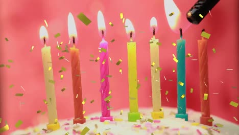 Animation-of-gold-confetti-falling-over-colourful-birthday-candles-on-cake-being-lit-on-pink