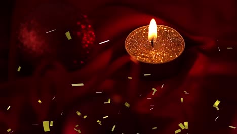 Animation-of-gold-confetti-falling-over-lit-tea-light-candle-on-dark-background