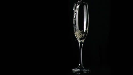 Animation-of-red-shapes-spinning-over-glass-of-champagne-on-black-background