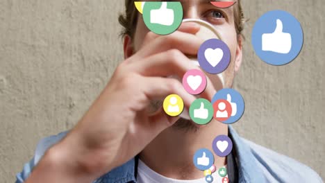 Animation-of-social-media-icons-over-man-drinking-coffee