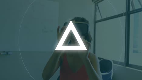 Animation-of-circle-and-triangle,-over-woman-wearing-vr-headset