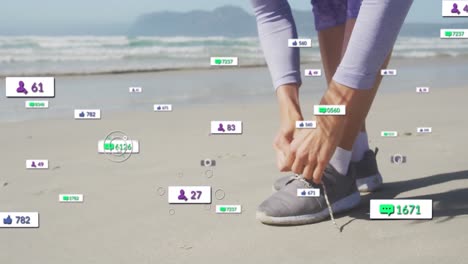 Animation-of-social-media-notifications,-over-woman-tying-shoe-on-beach