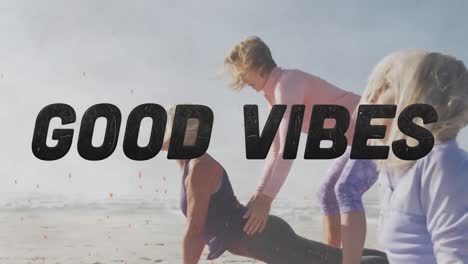 Animation-of-text-good-vibes,-in-black,-with-women-doing-yoga-on-beach