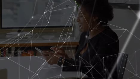 Animation-of-networks-of-connections-with-icons-over-woman-using-tablet