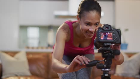 Mixed-race-woman-using-camera-making-vlog