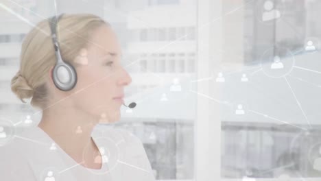 Animation-of-networks-of-connections-with-icons-over-businesswoman-using-phone-headsets