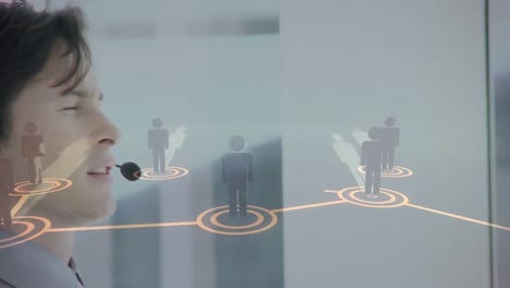 Animation-of-networks-of-connections-with-icons-over-businessman-using-phone-headsets