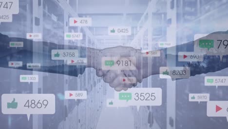 Animation-of-social-media-icons,-businessman-handshake-over-computer-servers