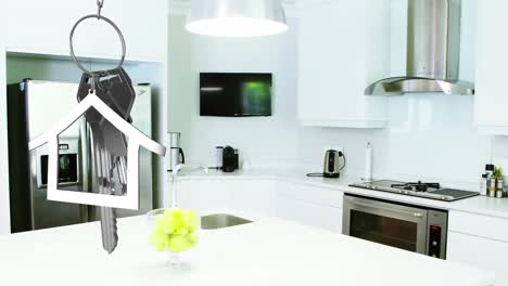 Animation-of-dangling-house-key-and-key-fob-over-modern-kitchen