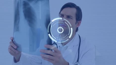 Animation-of-scope-scanning-over-male-doctor-holding-x-ray-photograph