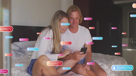 Animation-of-network-of-connections-with-icons-over-man-and-woman-using-smartphone
