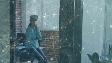 Animation-of-networks-of-connections-over-businesswoman-with-vr-headset-in-office