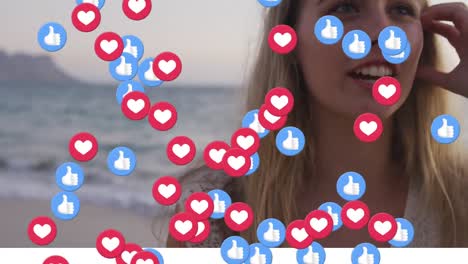 Animation-of-social-media-heart-and-thumbs-up-icons-over-happy-woman-on-beach