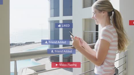 Animation-of-social-media-icons-over-happy-woman-using-smartphone-on-balcony