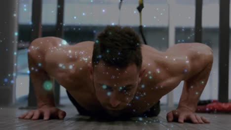 Animation-of-glowing-spots-over-strong-muscular-man-doing-push-ups