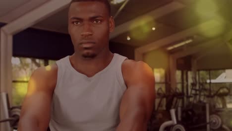 Animation-of-glowing-spots-over-man-exercising-in-gym
