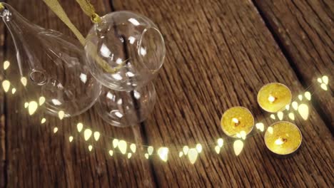 Animation-of-string-lights,-candles-and-christmas-decorations-on-wood-floor