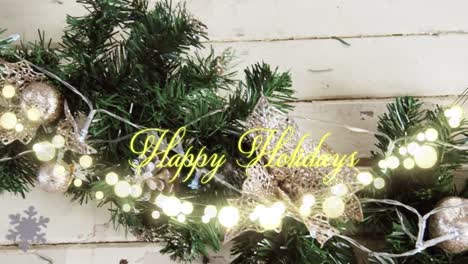 Animation-of-text,-happy-holidays,-in-yellow,-over-string-lights-and-christmas-decorations