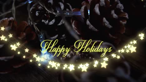 Animation-of-text,-happy-holidays,-in-yellow,-over-string-lights-and-pine-cones