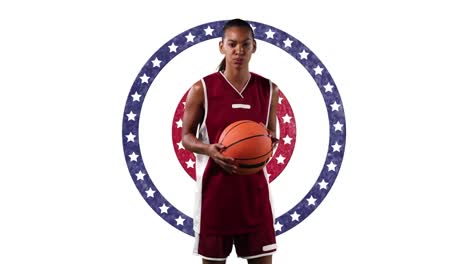 African-american-female-basketball-player-holding-basketball-against-stars-on-spinning-circles