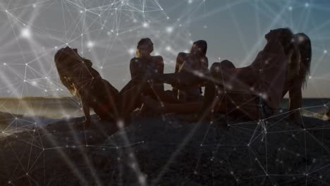 Animation-of-networks-of-connections-over-happy-group-of-friends-having-fun-at-the-beach