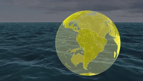Animation-of-yellow-globe-spinning-over-sea