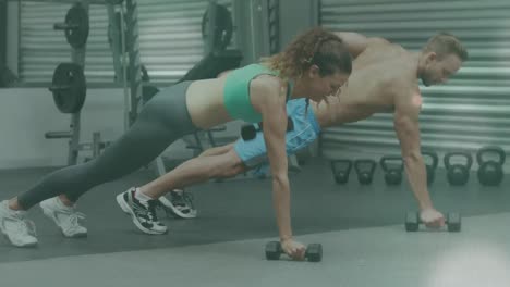 Animation-of-glowing-light-over-fit-man-and-woman-exercising-in-gym